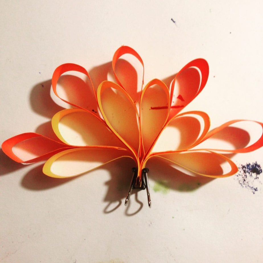 Stick the strips of one colour together in a fan shape. Glue the next colour in the gaps.
